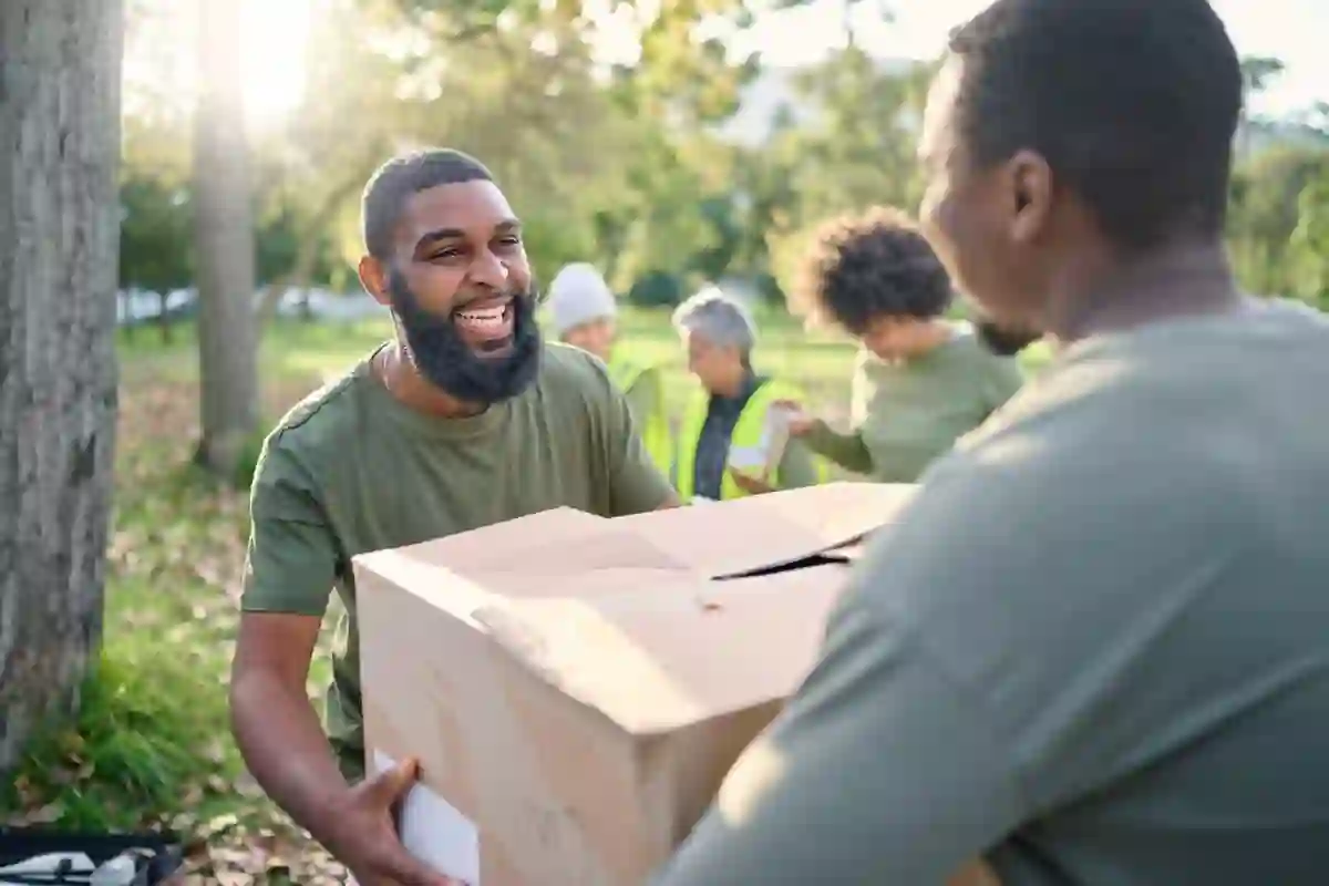Volunteers carrying donation boxes, illustrating community support and charitable efforts.